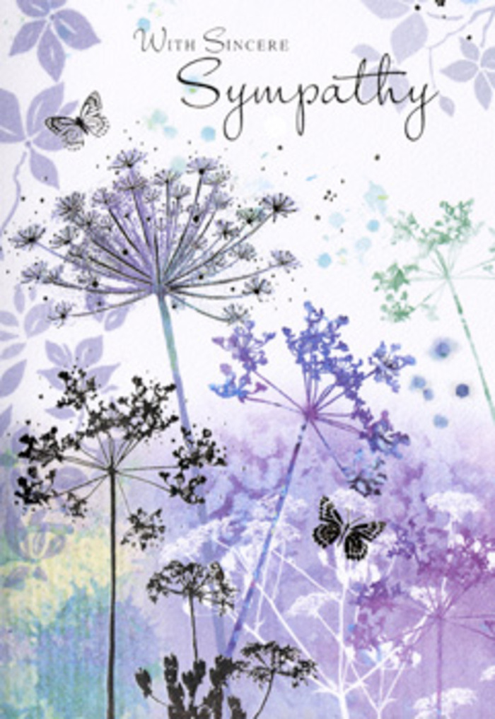 Opening this sympathy card, you are met with a soothing watercolour vignette that feels as calm and reflective as an unhurried evening near Golders Green's quiet residential streets. Tall, fine stems rise in loose, natural clusters from the bottom edge, each one bearing delicately drawn umbel-shaped flower heads that resemble wild cow parsley or Queen Anne's lace. The blossoms are shaded in cool, harmonious tones-lavender and heather purple mingled with soft indigo and misty blue-green. The petals and tiny seed clusters are hinted at rather than rigidly defined, lending a translucent, almost ethereal quality to the flowers, as if they are caught briefly in a veil of light. Behind them, the background is a gentle blur of colour, moving from muted violet to silvery blue-grey in smooth, cloud-like washes. This soft-focus treatment creates a sense of depth and distance without distracting from the main floral silhouettes. Floating around the upper stems, one or two butterflies drift quietly, their wings only lightly tinted with pale lilac and blue, suggesting both fragility and continuity. The ambient light in the artwork is diffuse, like the softened daylight of an overcast sky, wrapping every element in a sense of calm. Above the flowers, an understated condolence message appears in elegant script, offering words of sympathy that feel personal rather than formal. As a florist accustomed to designing funeral and memorial flowers for families in Golders Green and along Finchley Road, this card reflects the tone many people seek: gentle, sincere, and unintrusive. Its cool palette, open composition, and nature-inspired motifs make it an ideal choice to accompany a tasteful tribute delivered locally, offering a visual expression of care when words feel difficult.