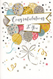 This photograph captures a charming congratulations card whose design feels as uplifting as sharing good news over coffee in Golders Green. At the centre, a bouquet-like cluster of illustrated balloons drifts upward, arranged with the same care you might expect in a hand-tied floral design. The balloons appear in a balanced mix of gold, silver, champagne, sky blue, blush pink, and soft grey, each one meticulously detailed. Some balloons are sprinkled with tiny stars that seem to twinkle; others feature gentle glitter effects or neat stripes, hinting at a subtle metallic shimmer. From the base of the cluster, slim ribbons drawn in gold and silver tones curl downwards in relaxed spirals, visually binding the balloons together while adding a sense of playful motion. Surrounding the balloons, a scattering of delicate stars, confetti dots, and looping party streamers floats across a pale, uncluttered background, suggesting the joyful energy of a celebration along Golders Green Road or near the station. A graceful banner drapes horizontally through the middle of the design, carrying the words 'Congratulations To You' in elegant, flowing calligraphy that radiates warmth and sincerity. The artwork hints at the feel of lightly raised glitter and glossy ink on your fingertips, enhancing the impression of quality and care. Emotionally, the card conveys pride, admiration, and genuine delight-perfect for acknowledging exam successes, promotions, or personal achievements. Paired with a fresh bouquet sourced locally, it becomes a complete gesture of celebration for friends, family, or colleagues living in and around Golders Green.